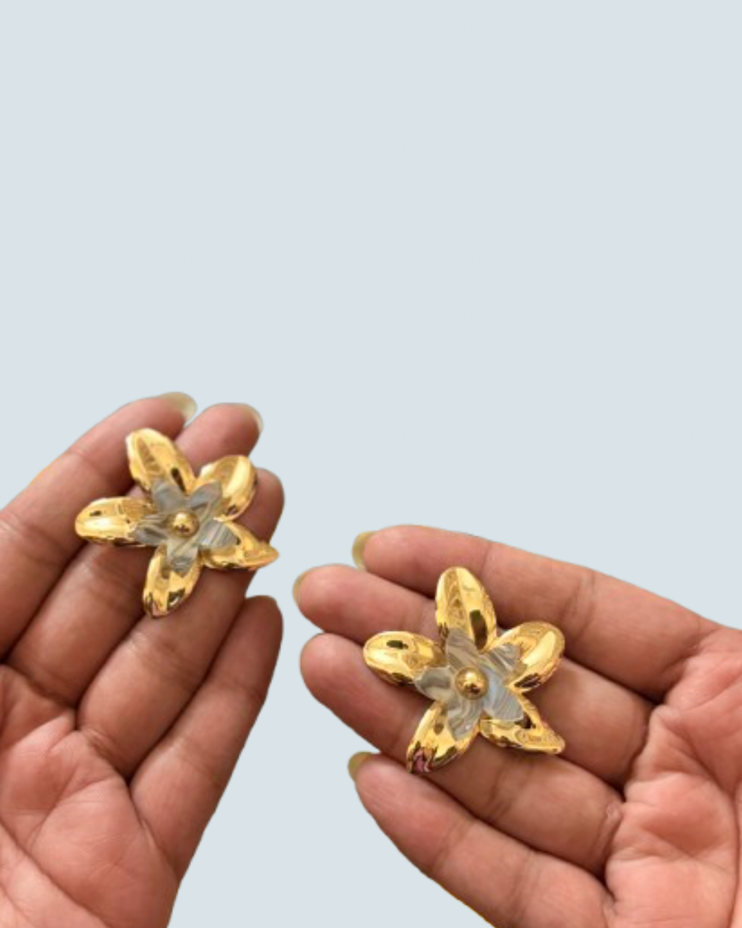 Minimalist ivory layered bloom gold studs held in hand to show scale - Trinketly BD
