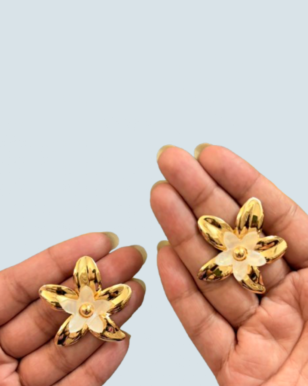 Minimalist ivory layered bloom gold studs held in hand to show scale - Trinketly BD
