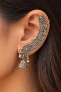 Close-up of vintage-style floral oxidized silver cuff earrings worn on the ear - Trinketly BD
