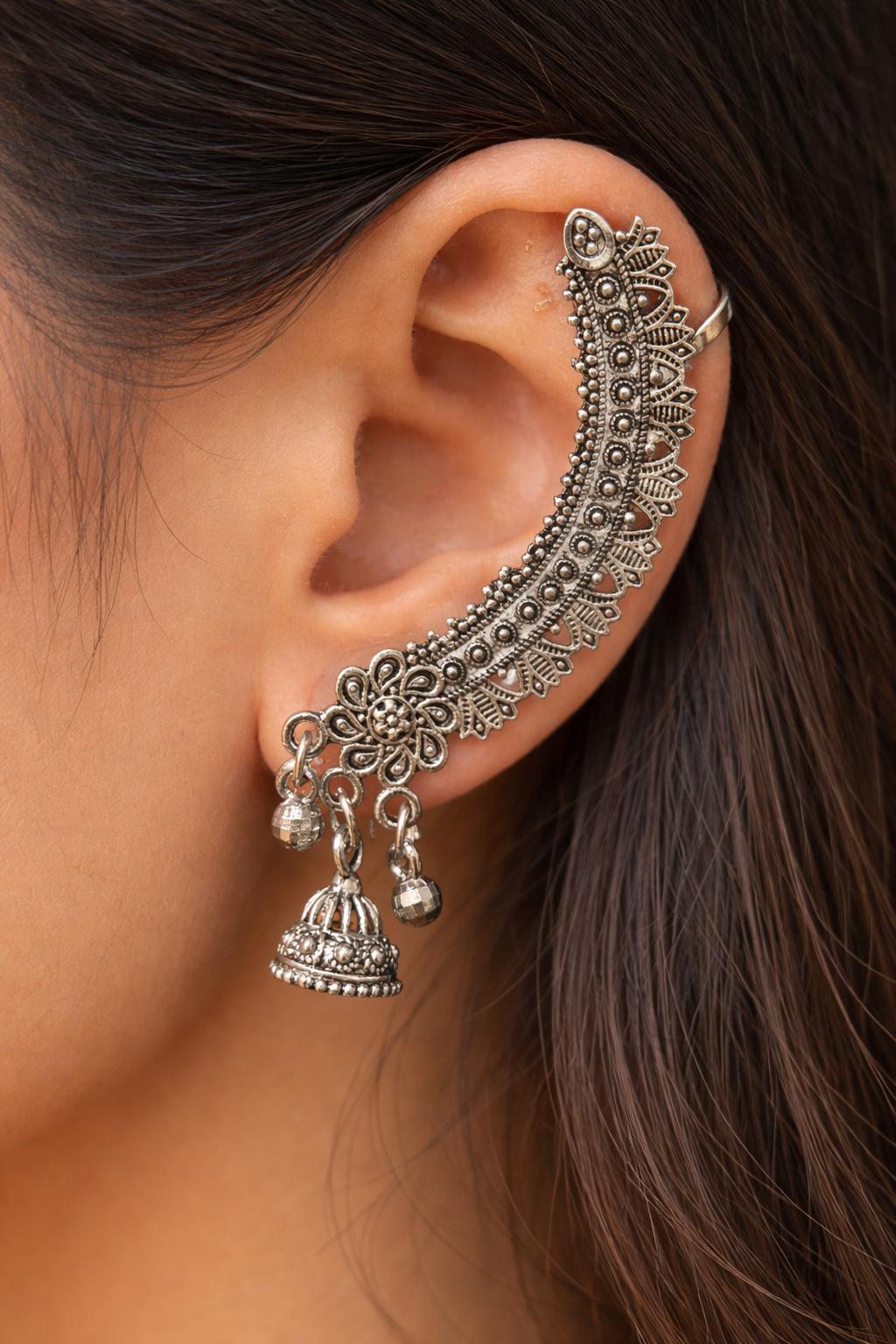 Close-up of vintage-style floral oxidized silver cuff earrings worn on the ear - Trinketly BD

